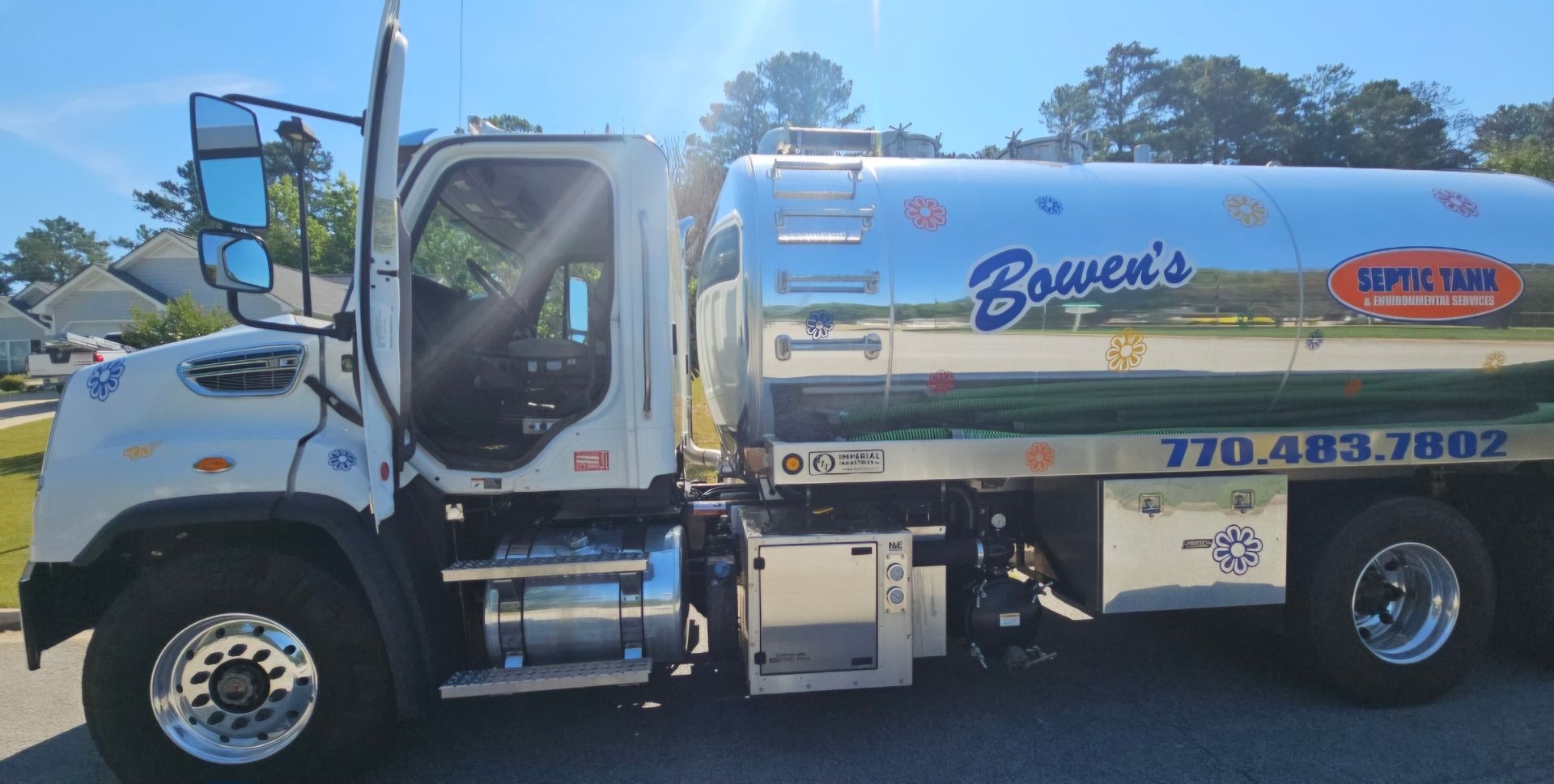 A tanker truck is parked on the side of the road.