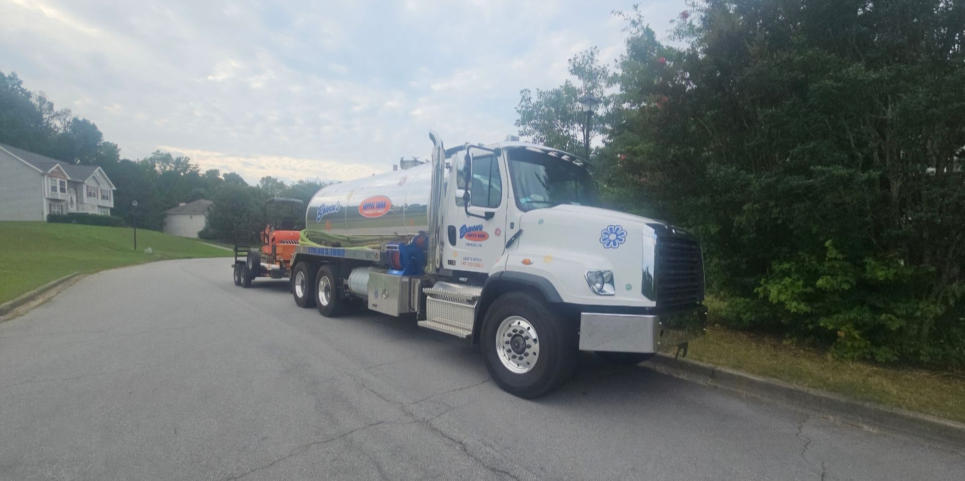 A tanker truck is parked on the side of the road.