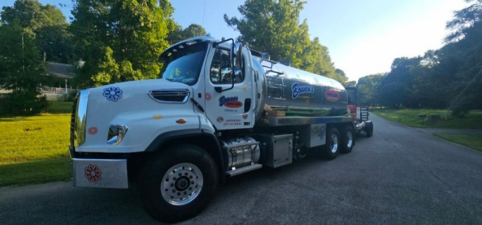 A large white truck is parked on the side of a road.