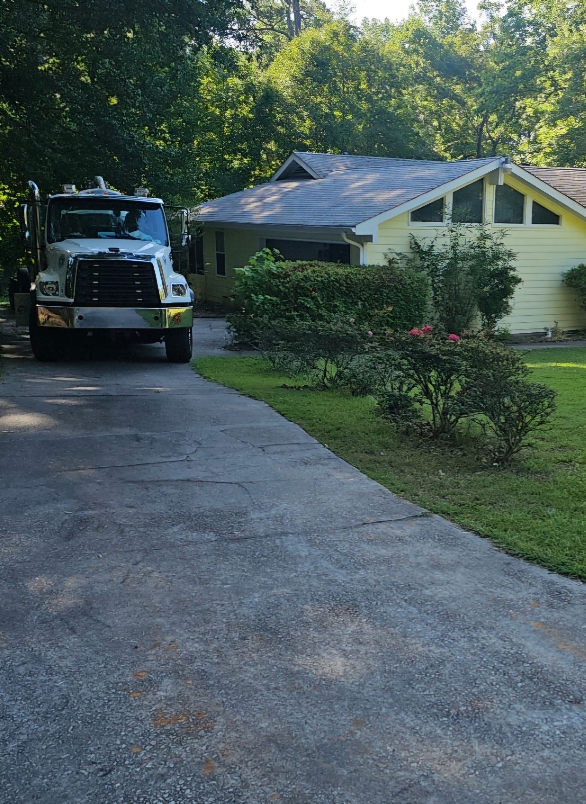 A truck is parked in the driveway of a house.