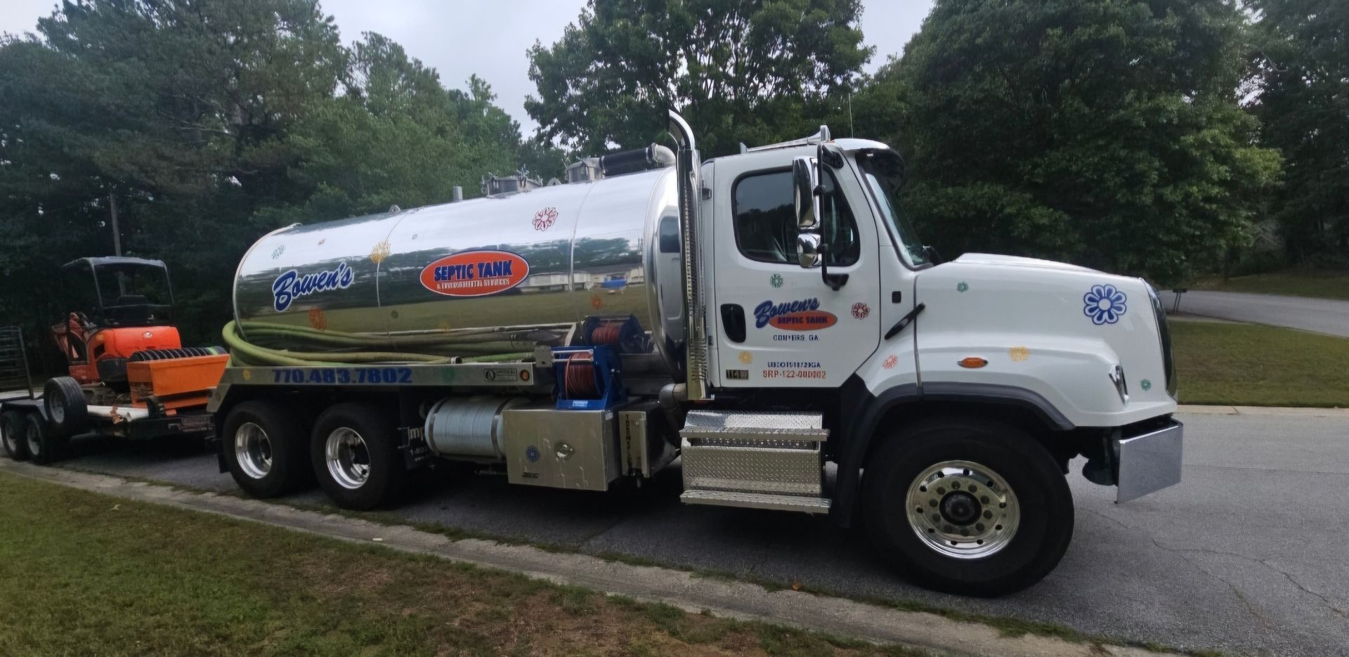 A large white truck is parked on the side of the road.