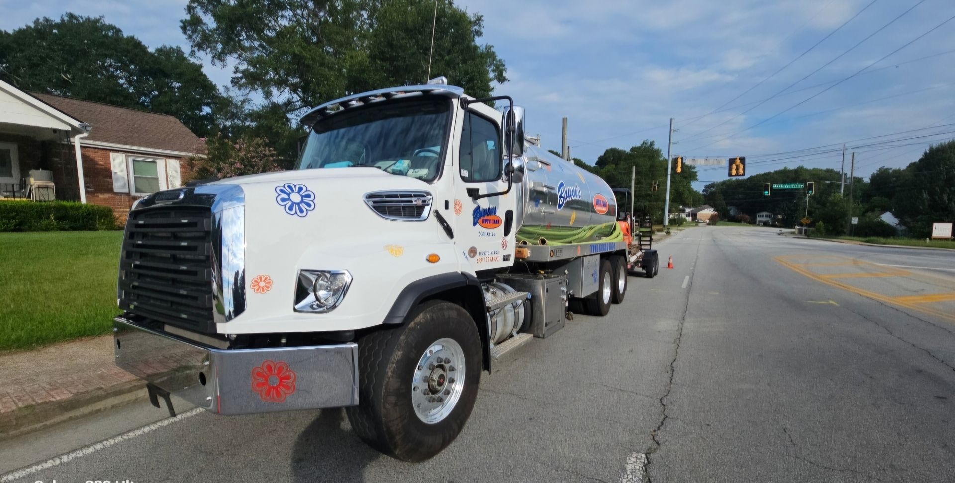 A white truck is parked on the side of the road.