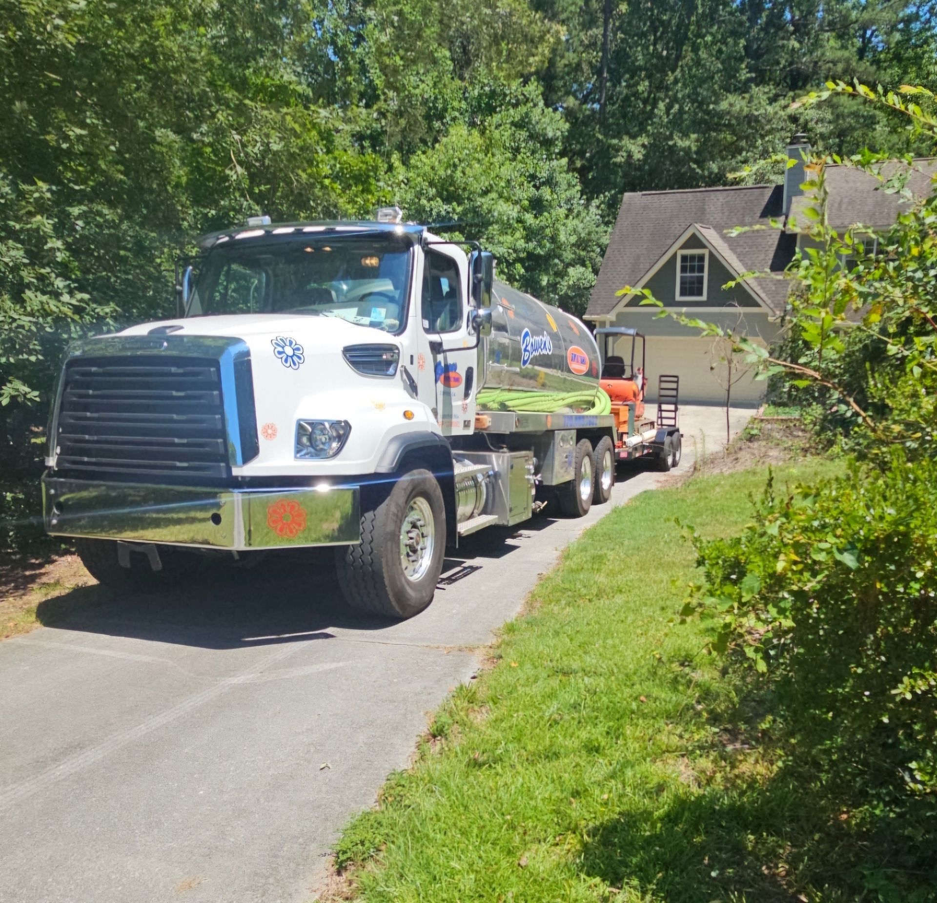 A tanker truck is parked on the side of the road