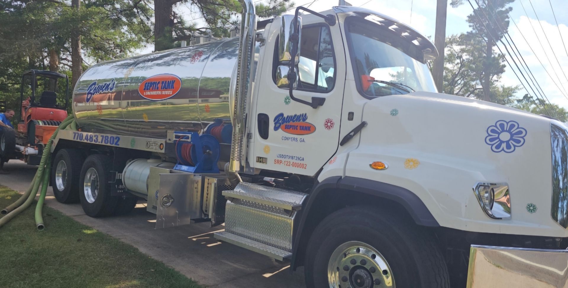 A large white truck is parked on the side of the road.