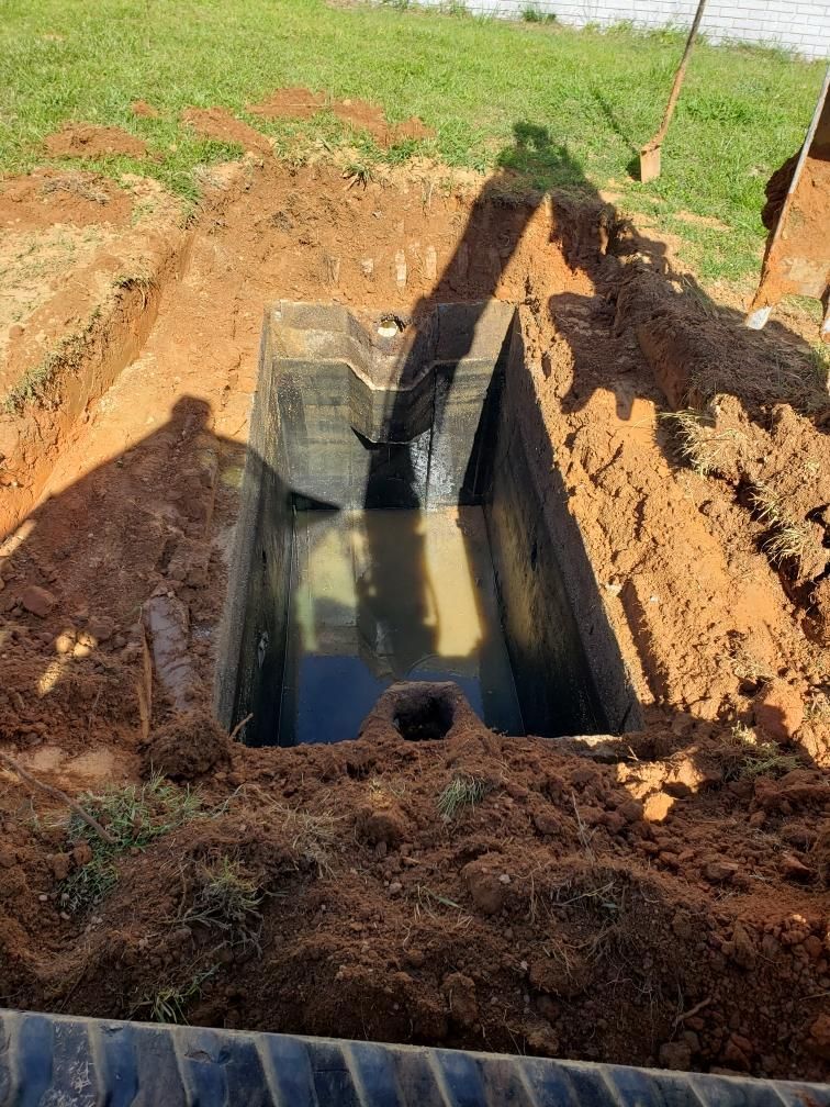 A Man Is Digging a Hole in The Ground with A Shovel.