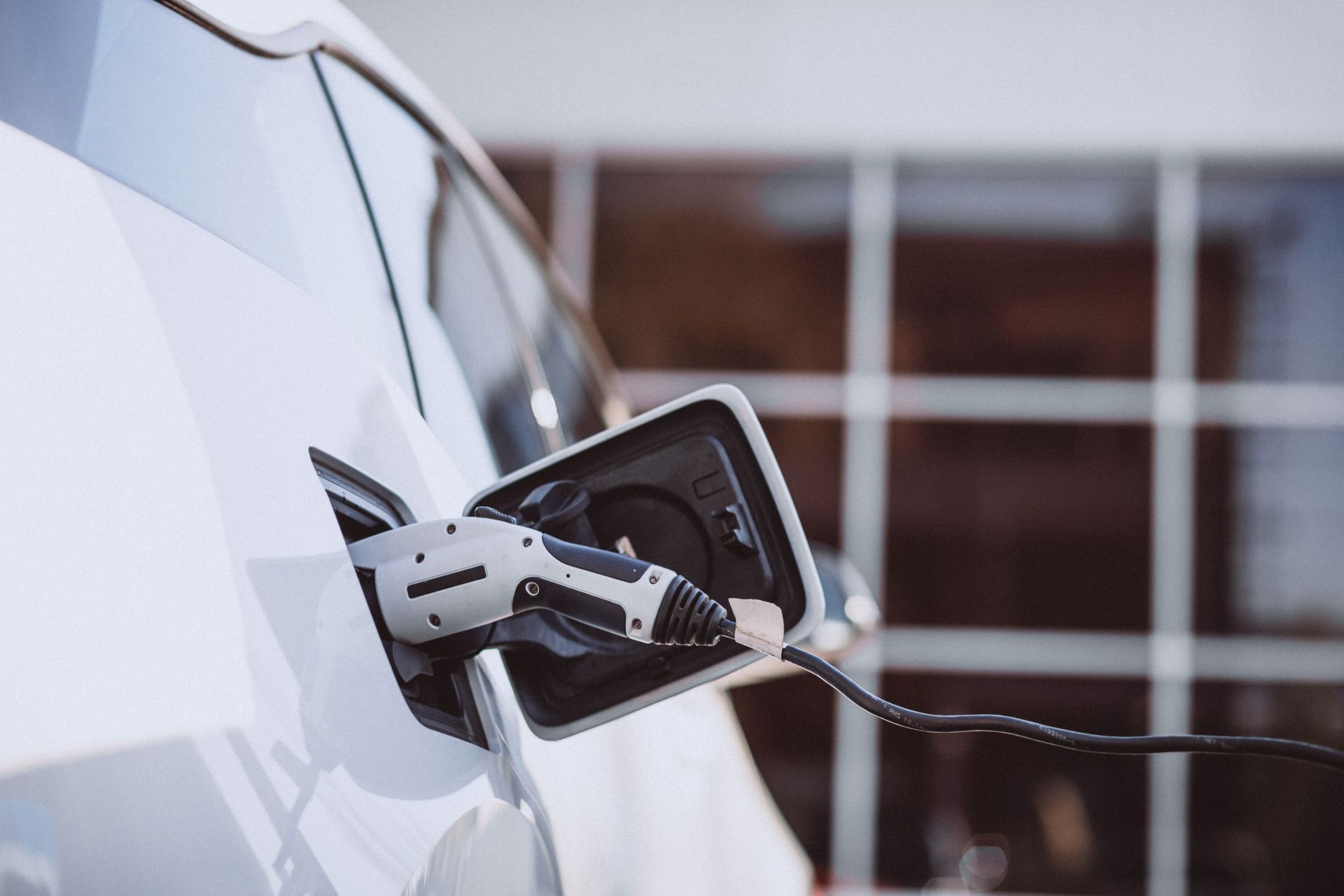 An electric car being charged at a charging station.