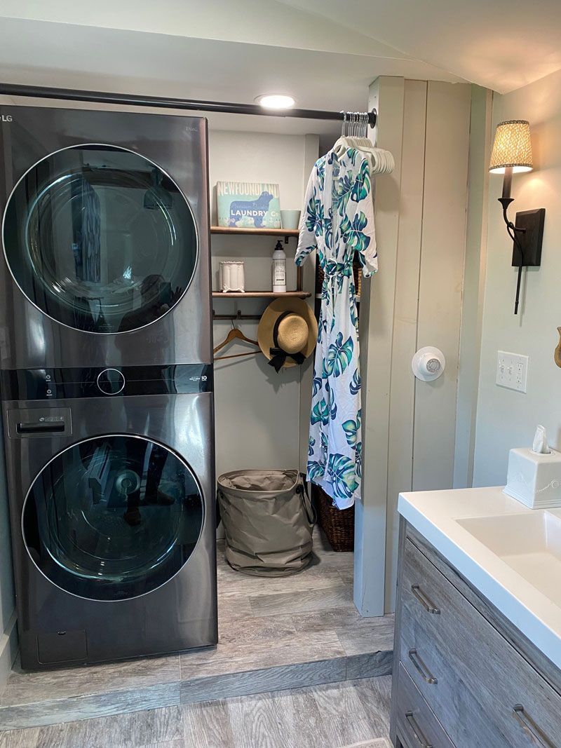 A recently remodeled bathroom with a stackable washer and dryer