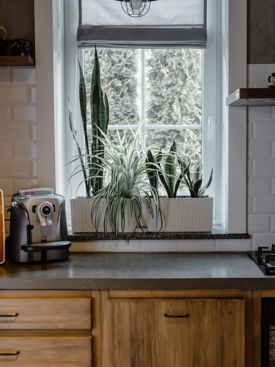 a farmhouse style kitchen with wooden cabinetry and brick accent wall with a tile backsplash