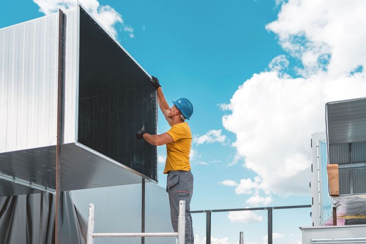 Man installing an air duct system | Perth, WA | Commercial Air Solutions