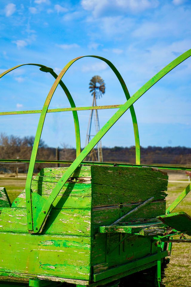 old wagon in front of windmill