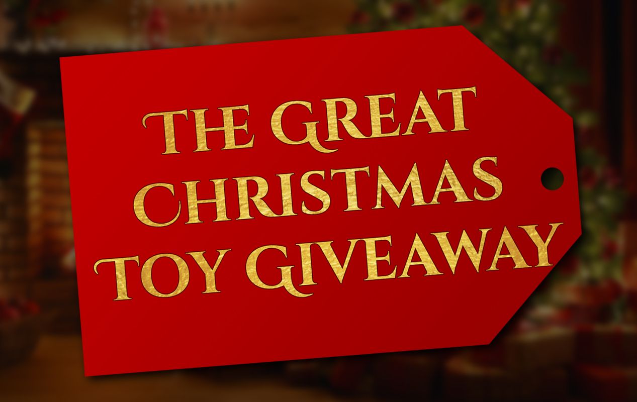 Red gift tag with gold text: "THE GREAT CHRISTMAS TOY GIVEAWAY." Blurred background.