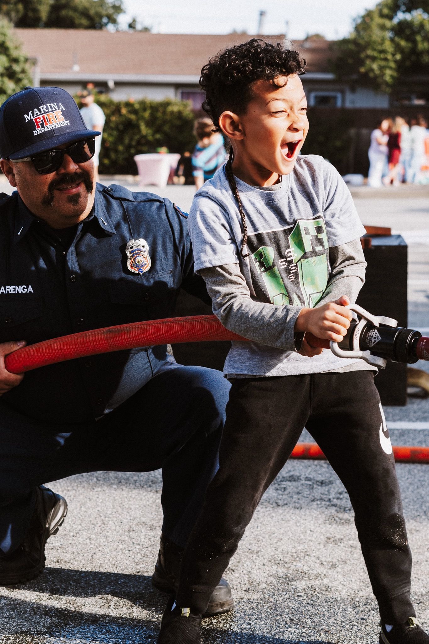 Choir on stage, singing with hands raised—blue stage lighting. Audience member signing below.