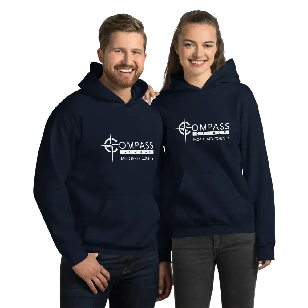 Two people wearing Compass Church logo apparel, smiling. Man in blue jacket, holding mug; woman in hoodie, holding water bottle.