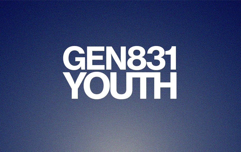 Group of people in a room, heads bowed, possibly praying or in silent reflection.