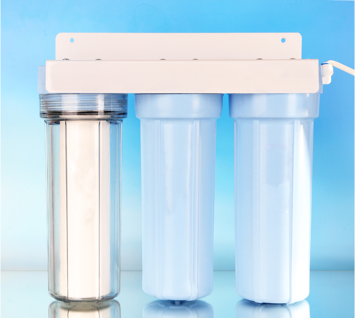 A water filter is sitting on top of a glass table.