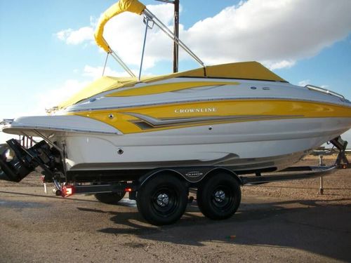 A yellow and white boat is on a trailer