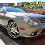 A silver car is parked on the side of the road.