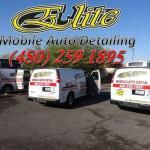 A bunch of vans are parked in a parking lot.