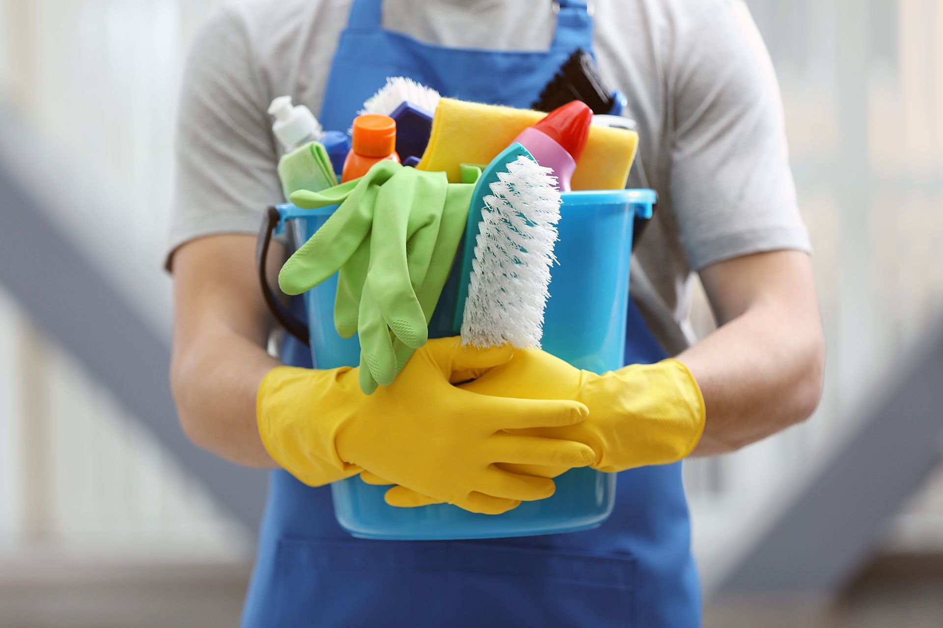 Man Holding Cleaning Supplies