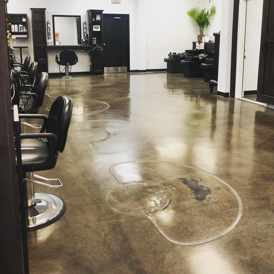 Hair salon interior with stained concrete floor.