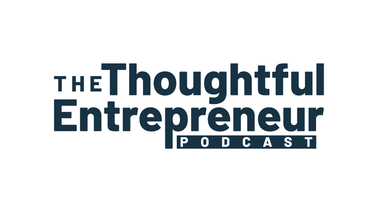 Ron Shaich is smiling in front of a panera bread store