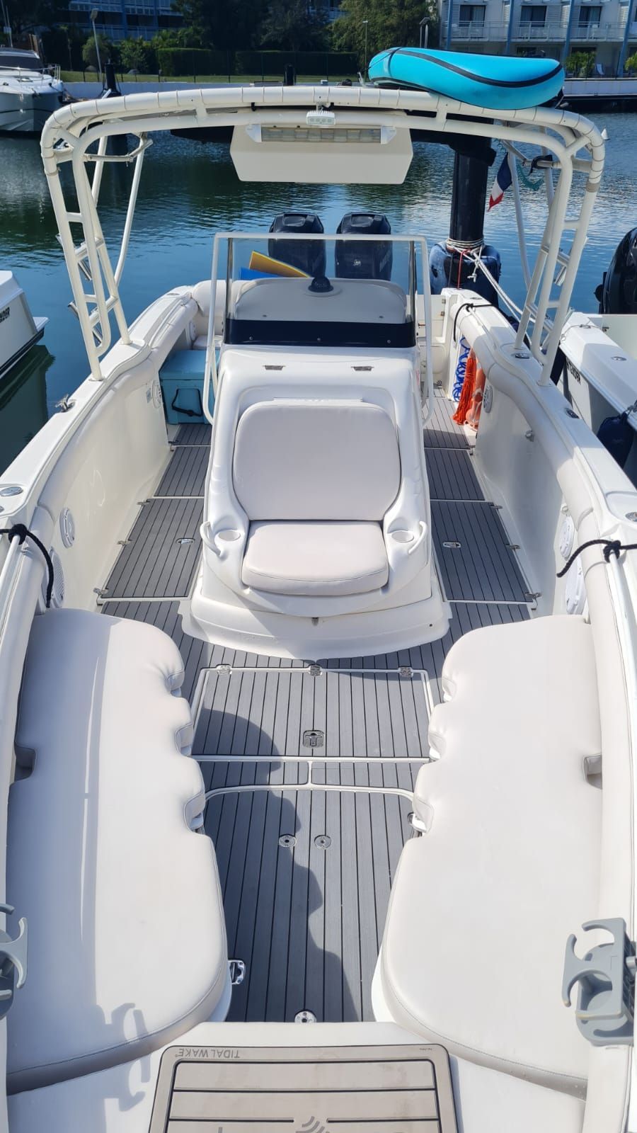White boat interior with center console, two outboard motors, and seating.