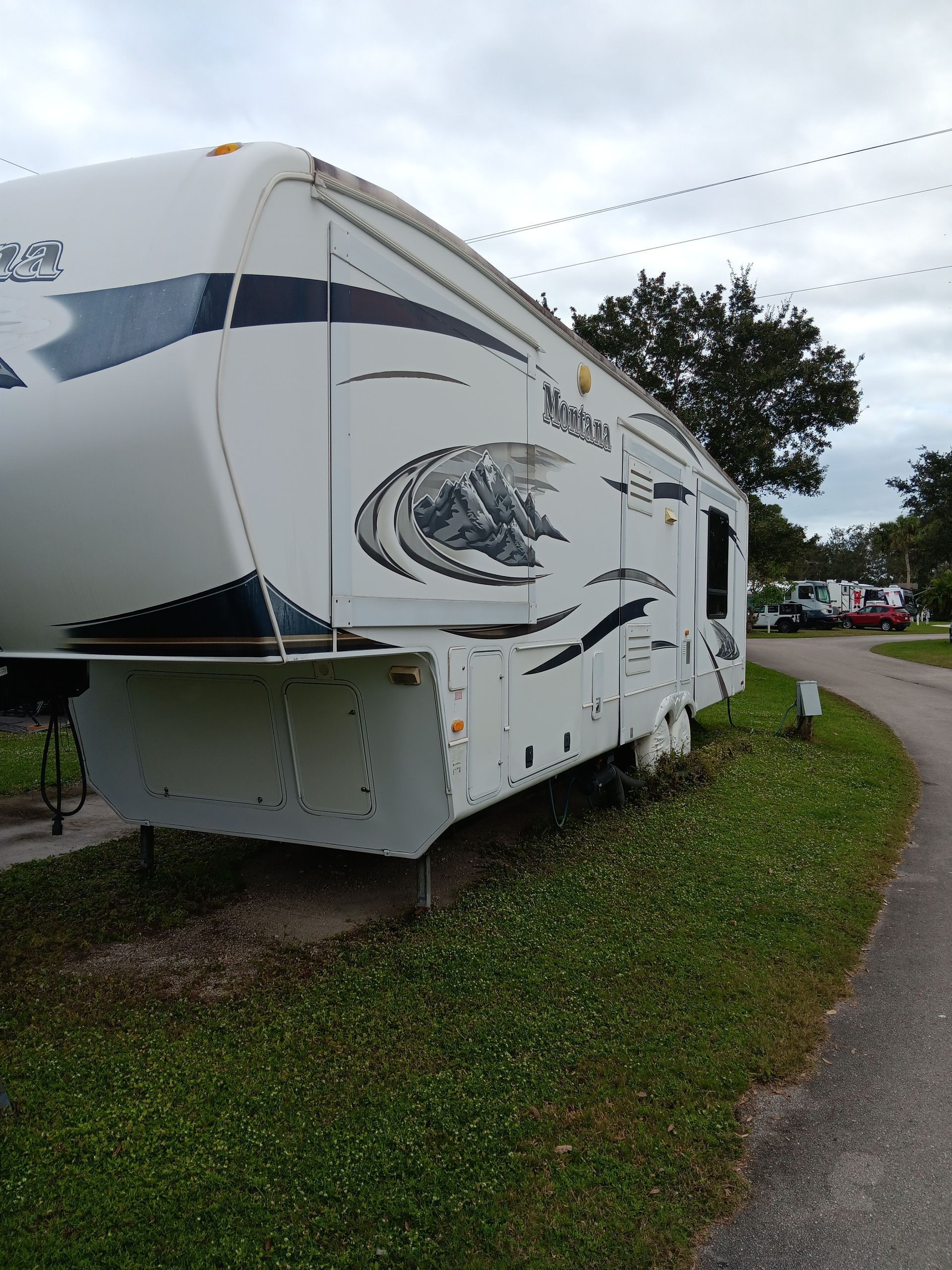 A white RV is parked on the side of the road