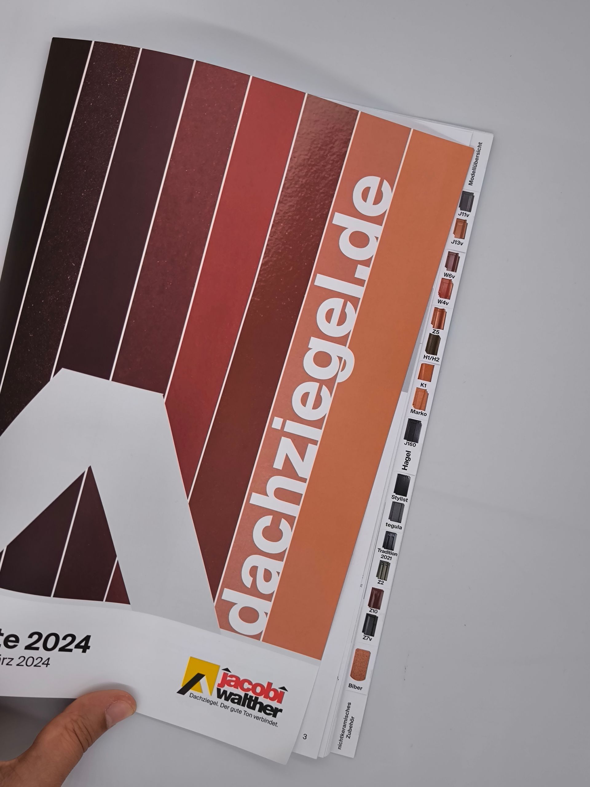 Eine Person hält ein Buch mit der Aufschrift dachziegel.de