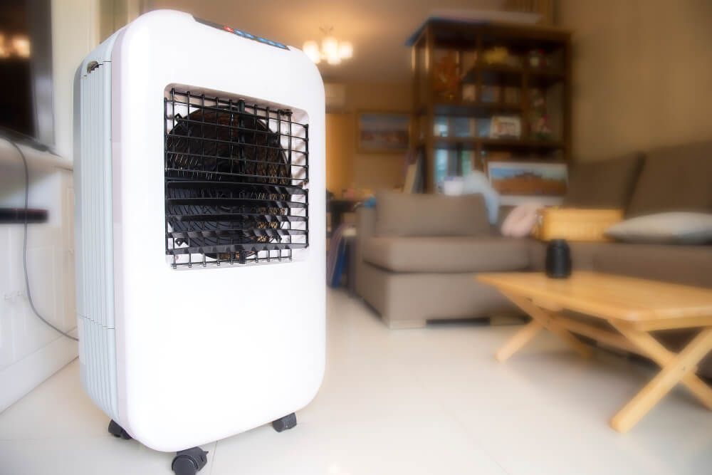 A White Air Cooler Enhances Comfort in a Living Room Beside a Couch — Refrigerated Technologies (QLD) Pty Ltd In Cannonvale, QLD