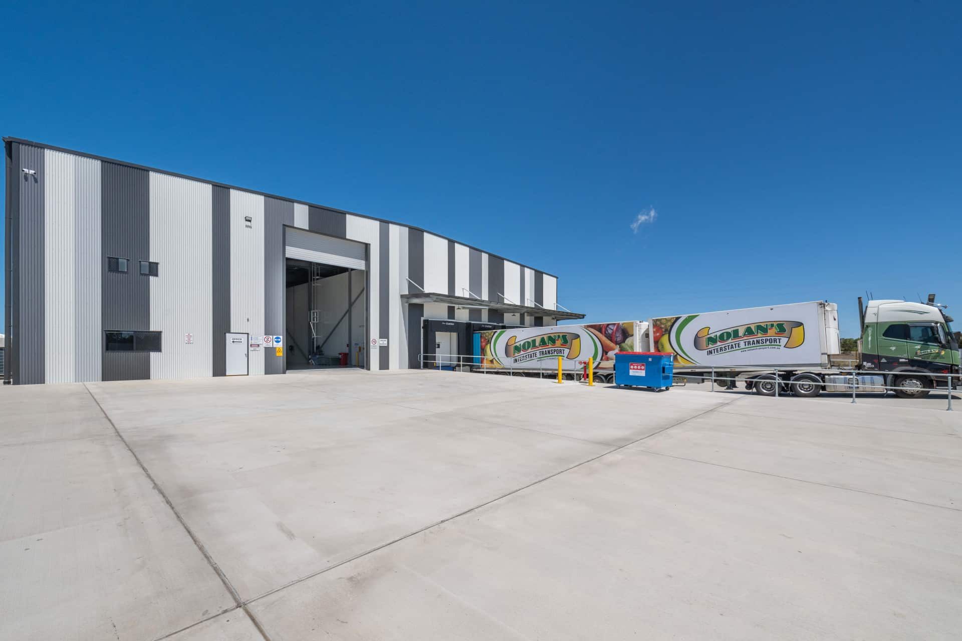 A Truck is Parked in Front of a Large Building — Refrigerated Technologies (QLD) Pty Ltd In Bowen, QLD