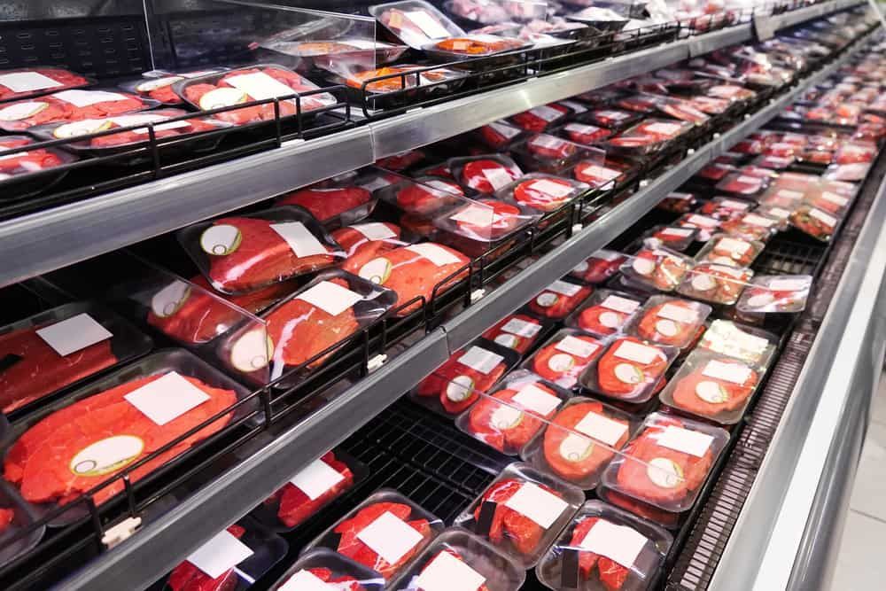 A Refrigerator Filled With Lots of Meat in Plastic Containers in a Grocery Store — Refrigerated Technologies (QLD) Pty Ltd In Airlie Beach, QLD