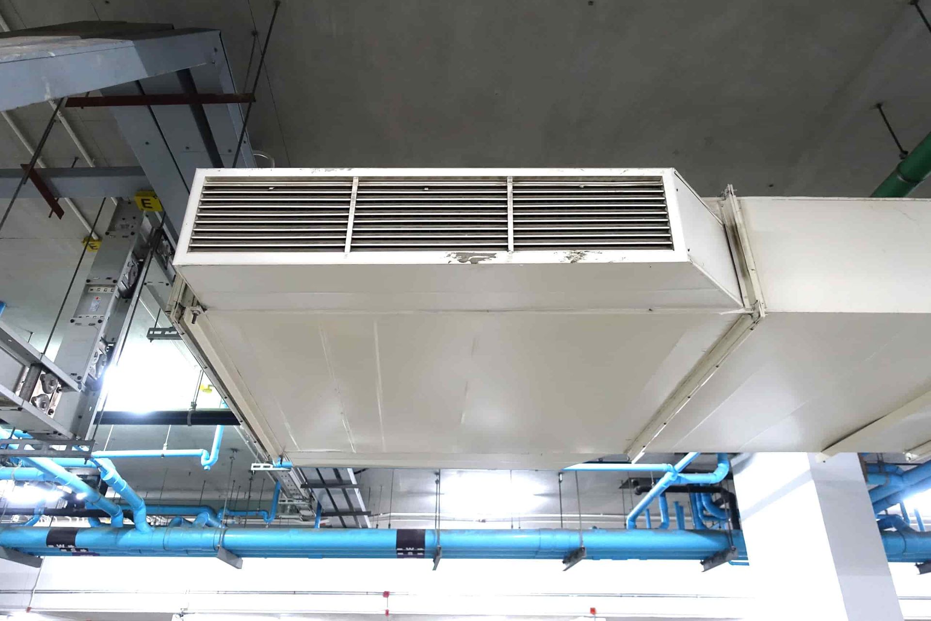 A White Air Duct is Hanging From the Ceiling of a Building — Refrigerated Technologies (QLD) Pty Ltd In Proserpine, QLD
