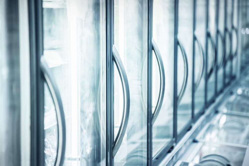 A Row of Refrigerators With Glass Doors in a Store — Refrigerated Technologies (QLD) Pty Ltd In Collinsville, QLD