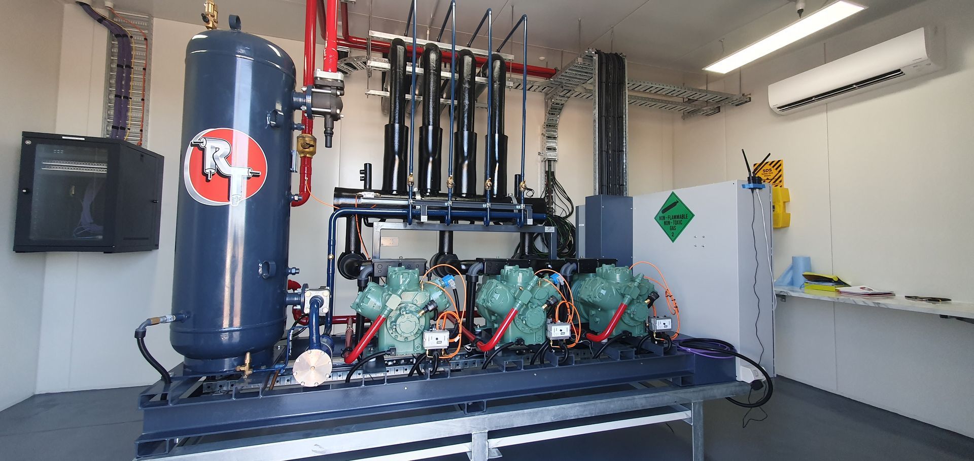 A Room With a Lot of Pipes and a Machine That Says Rn on It