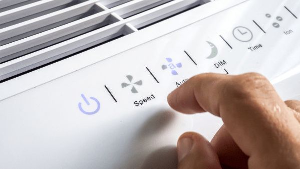 A Person is Pressing a Button on a Humidifier — Refrigerated Technologies (QLD) Pty Ltd In Collinsville, QLD