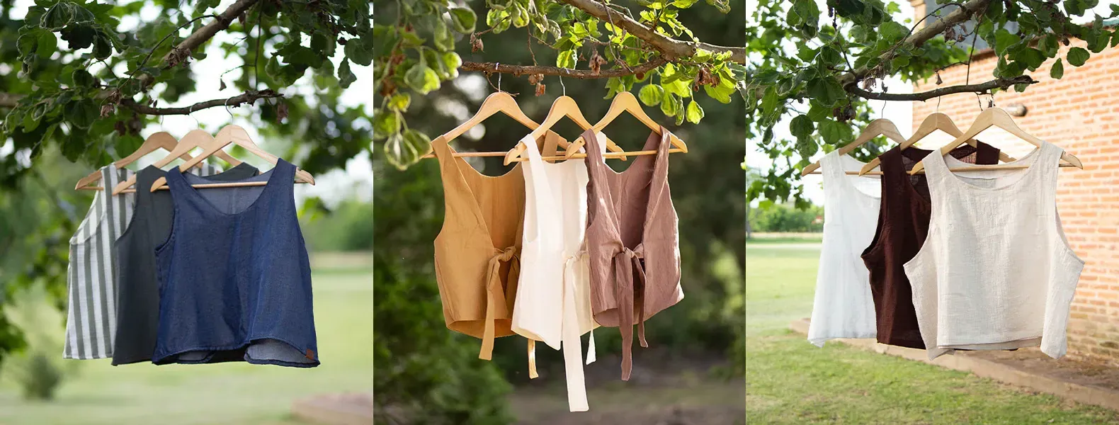 Tres conjuntos de blusas sin mangas cuelgan de la rama de un árbol: azul, marrón, blanco y tostado.