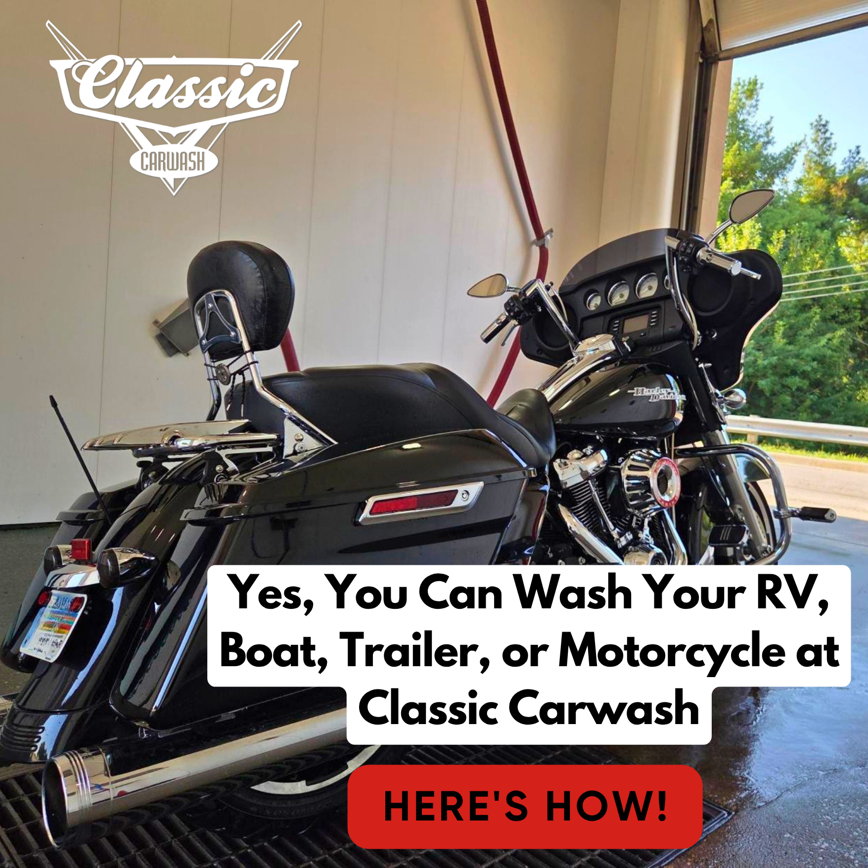 Black motorcycle in a car wash bay with text promoting RV, boat, trailer, and motorcycle washing at Classic Carwash