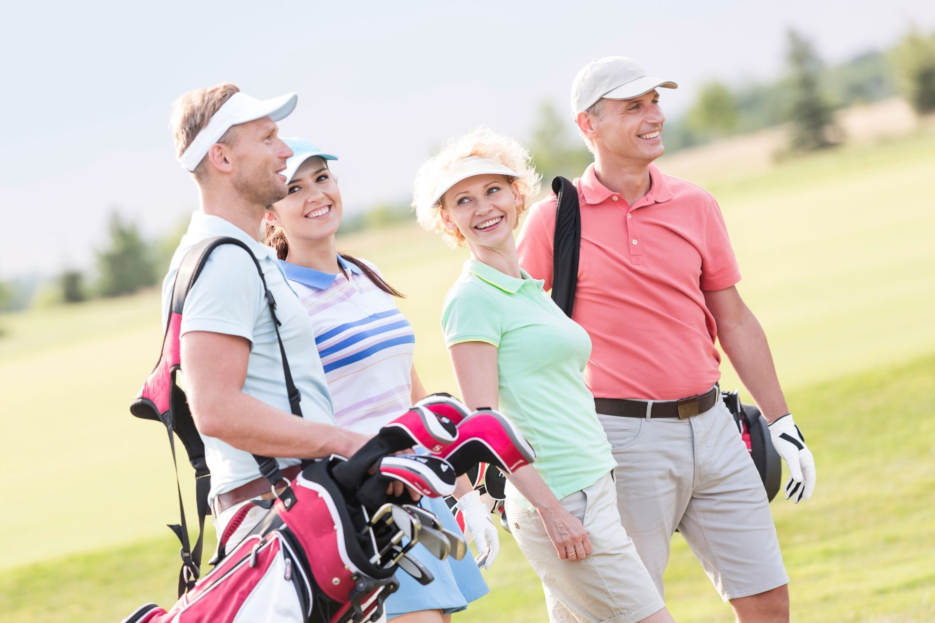 A group of people about to play golf. A group of people about to play golf.