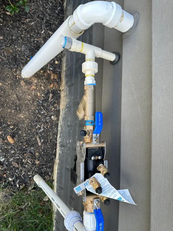 a close up of a pipe with a blue valve on it