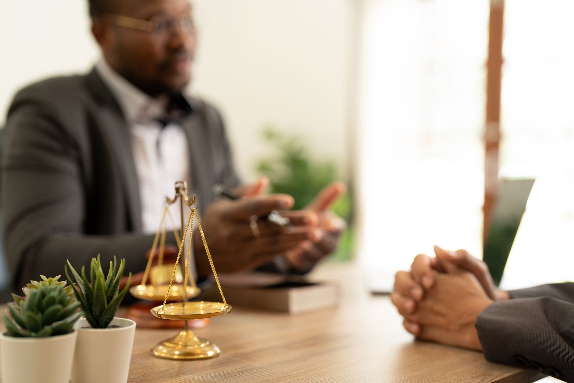 A lawyer is sitting at a table talking to a client.