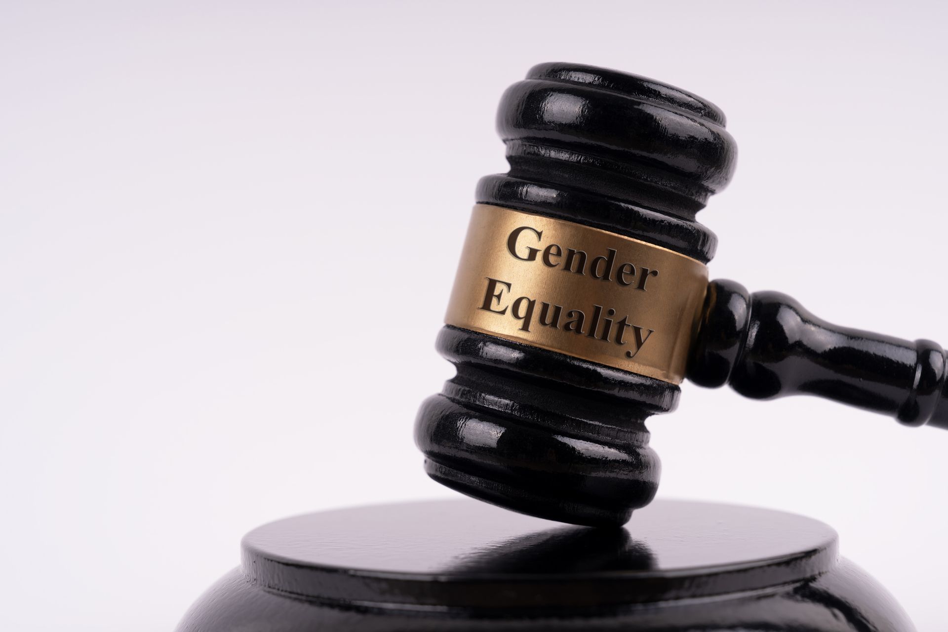A judge 's gavel that says gender equality on it
