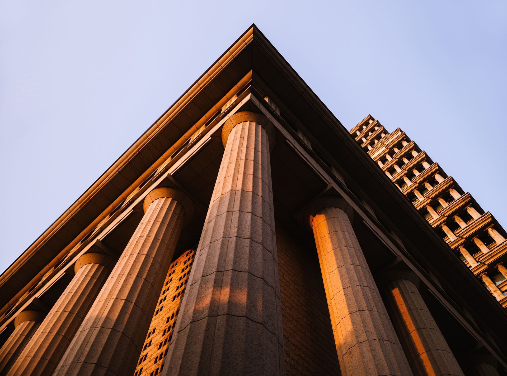 Looking up at the top of a building with columns