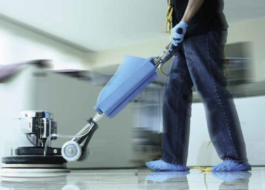A person is using a machine to clean a floor.