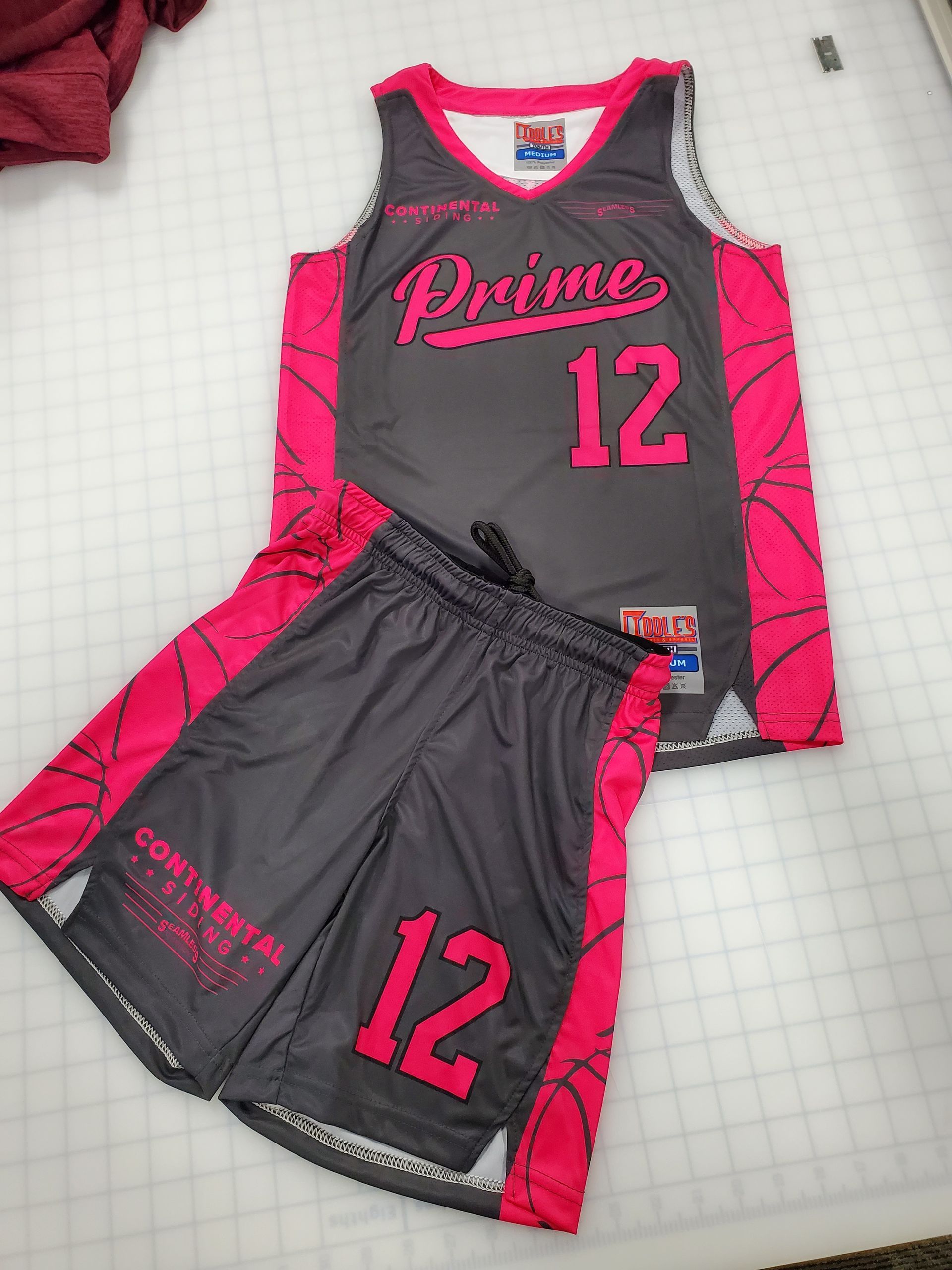 Gray and pink basketball jersey and shorts