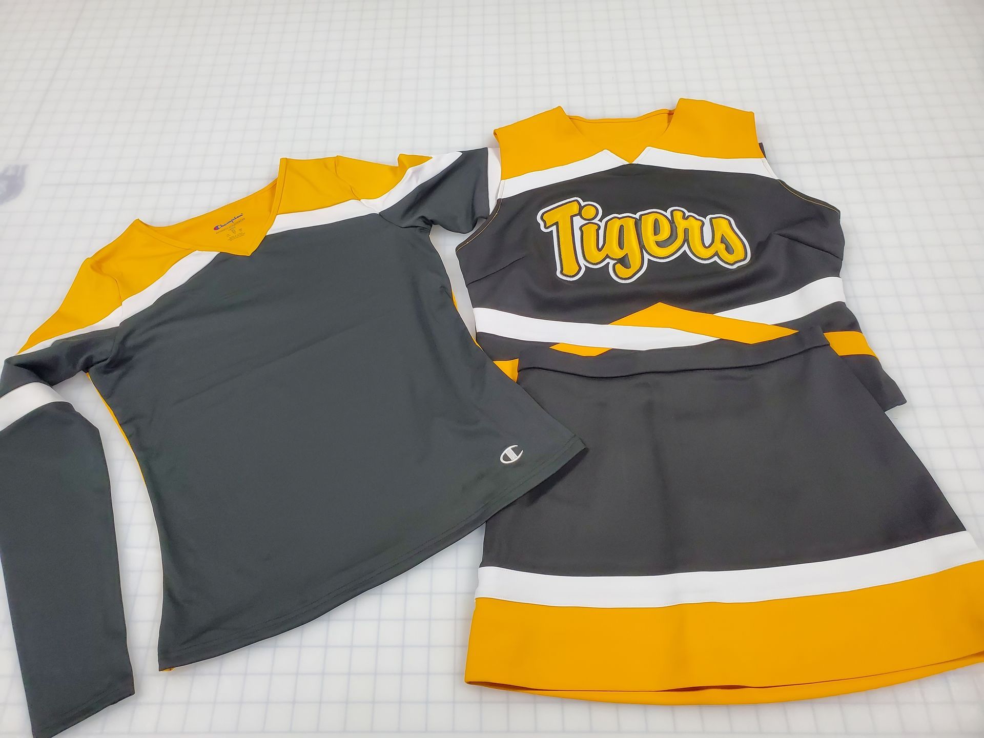 Cheerleading uniform set: gray, yellow, and white top and skirt