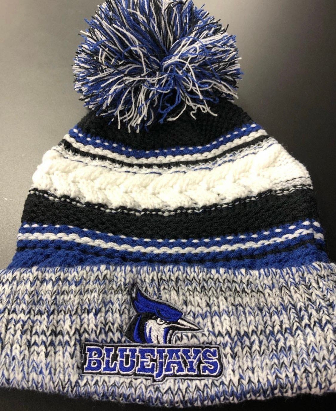 Blue and black winter hat with bluejays logo