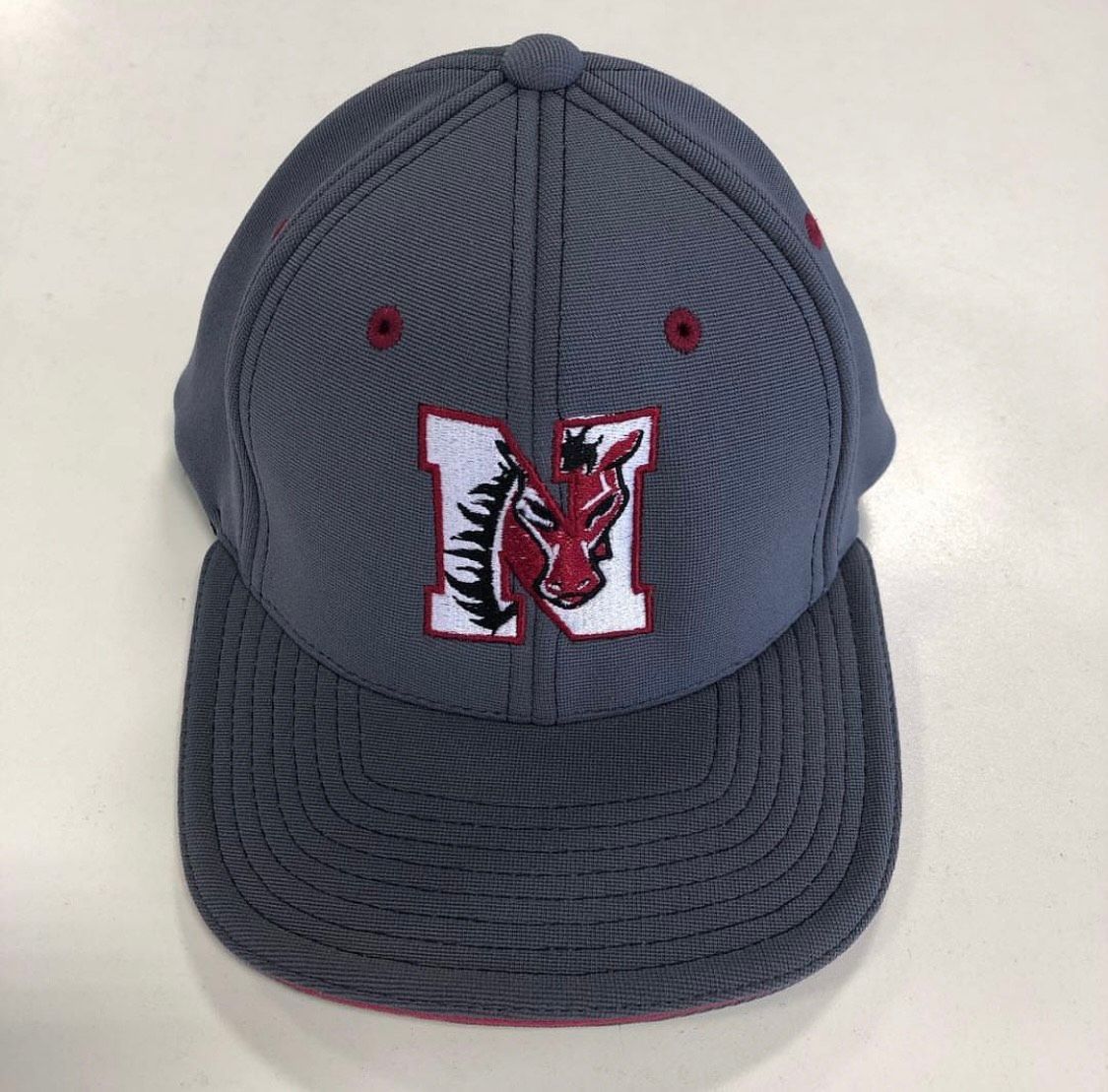 Gray baseball cap with a red and white logo 