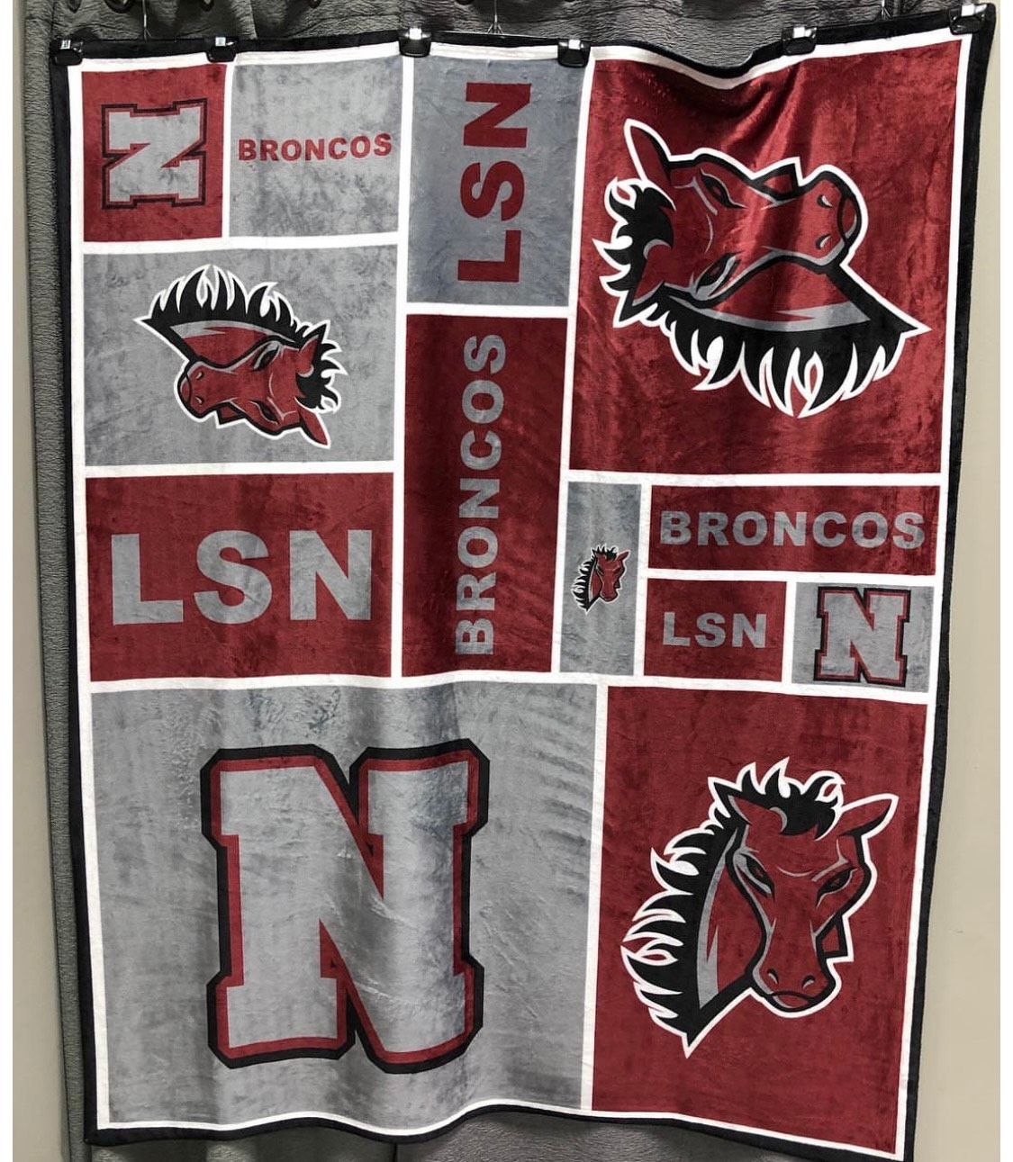 Blanket with red and gray Broncos logos