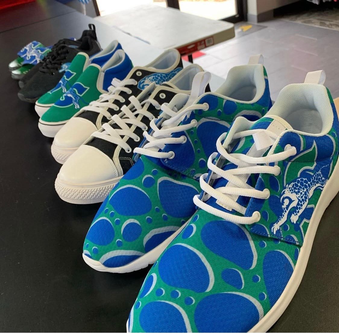 Lineup of patterned sneakers in green, blue, and black.