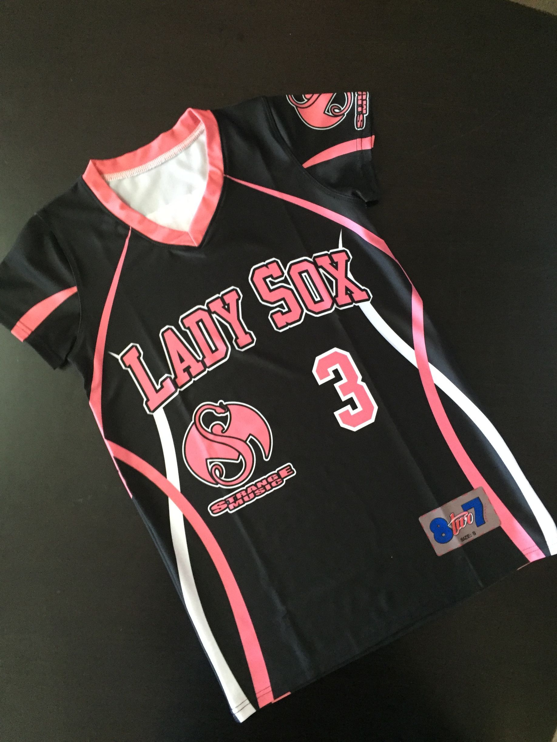 Black softball jersey with pink and white accents